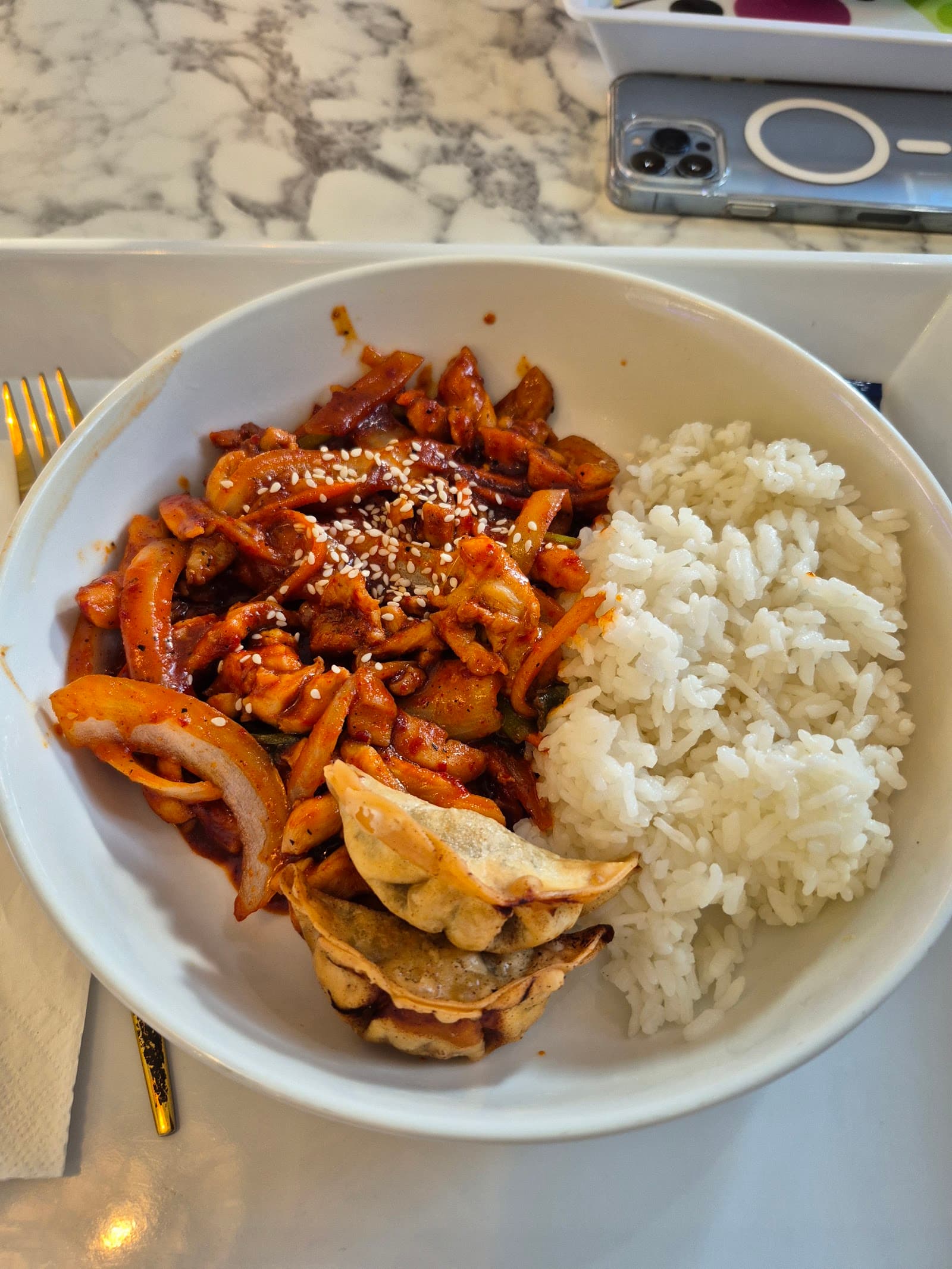Spicy chicken DupBap bowl with rice and a dumpling