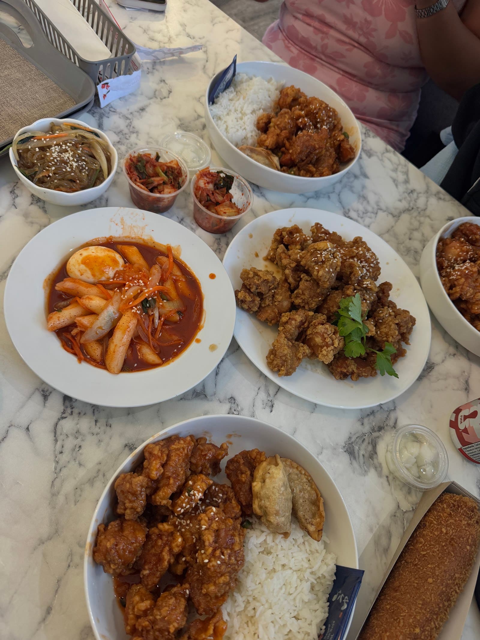 A table full of Korean fried chicken plates being shared